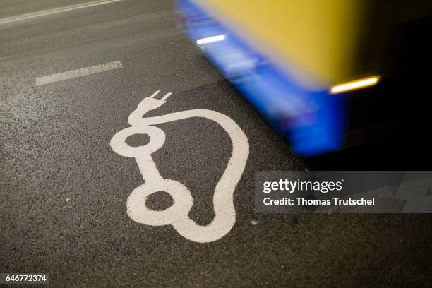 Vilnius, Lithuania Cars pass a pictogram of an electric car on a road on March 01, 2017 in Vilnius, Lithuania.