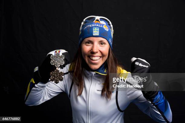 In this handout supplied by Nordic Focus, Charlotte Kalla of Sweden poses with the silver medal won in the Women's Cross Country 10km during the FIS...