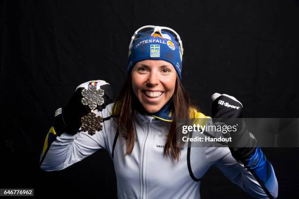 In this handout supplied by Nordic Focus, Charlotte Kalla of Sweden poses with the silver medal won in the Women's Cross Country 10km during the FIS...