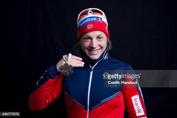 In this handout supplied by Nordic Focus, Astrid Uhrenholdt Jacobsen of Norway poses with the bronze medal won in the Women's Cross Country 10km...