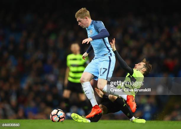 Kevin De Bruyne of Manchester City holds off Jon Gorenc Stankovic of Huddersfield Town during The Emirates FA Cup Fifth Round Replay match between...