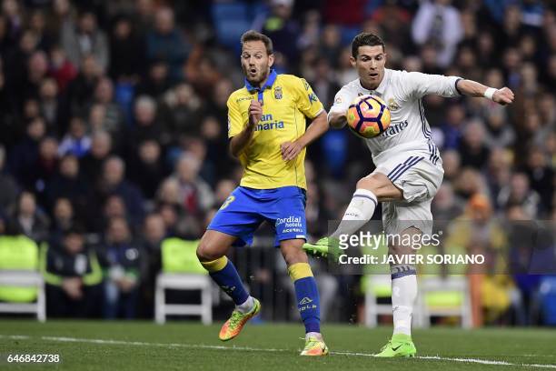 Real Madrid's Portuguese forward Cristiano Ronaldo vies with Las Palmas' defender Daniel Castellano during the Spanish league football match Real...