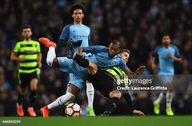 Fernandinho of Manchester City battles with Martin Cranie of Huddersfield Town during The Emirates FA Cup Fifth Round Replay match between Manchester...