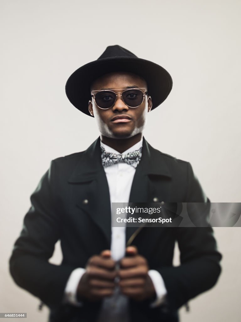 Retro african man in black suit and hat