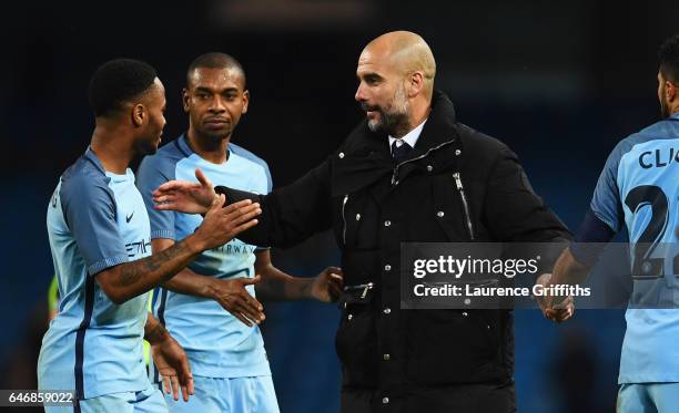 Josep Guardiola manager of Manchester City celebrates with Raheem Sterling, Fernandinho and Gael Clichy of Manchester City after victory in The...