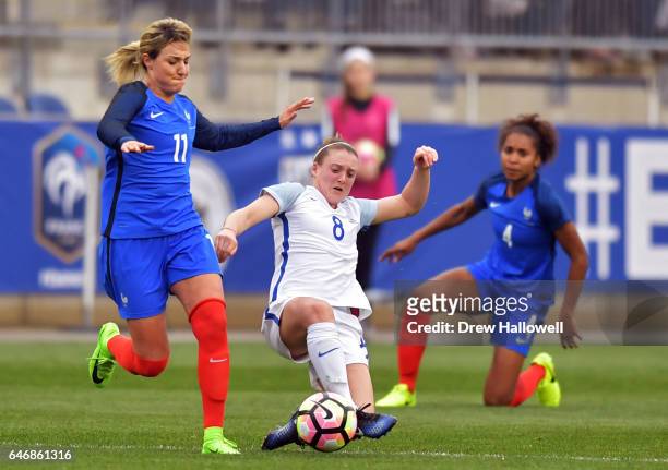 Jade Moore of England kicks the ball away from Claire Lavogez of France as Laura Georges looks on during the SheBelieves Cup at Talen Energy Stadium...