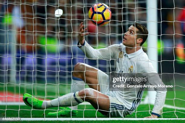 Cristiano Ronaldo of Real Madrid CF picks the ball after scoring their second goal during the La Liga match between Real Madrid CF and UD Las Palmas...