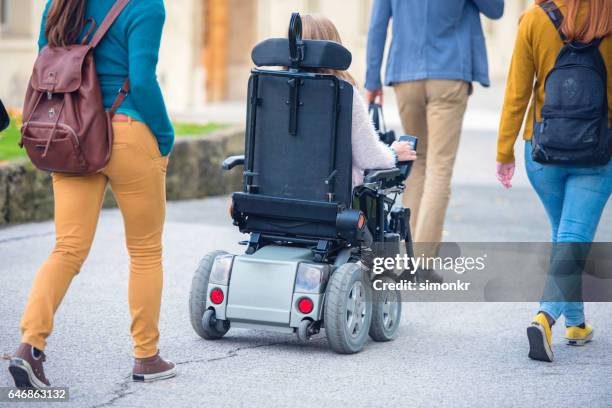 university students walking in campus - motorized wheelchair stock pictures, royalty-free photos & images