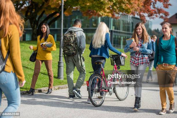 university students walking in campus - collegebasket stock pictures, royalty-free photos & images