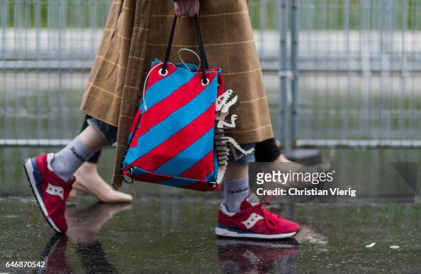 Red, blue striped bag outside Dries Van Noten on March 1, 2017 in Paris, France.