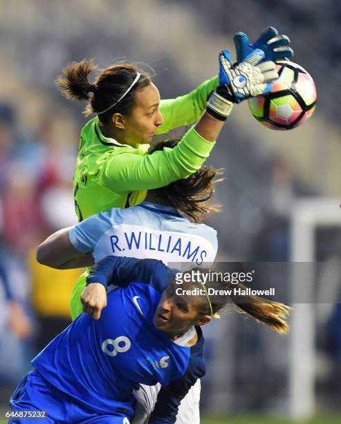 Sarah Bouhaddi of France makes a save over Rachel Williams of England and teammate Jessica Houara during the SheBelieves Cup at Talen Energy Stadium...