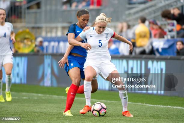 English Defender Steph Houghton keeps the ball from French Forward Marie-Laure Delie in the first half during the game between the England Women's...