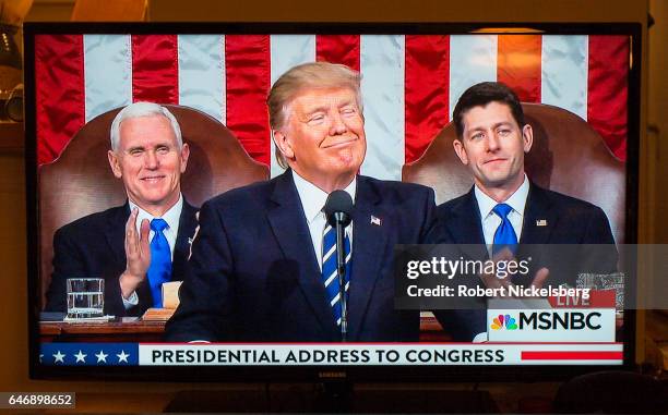 Picture taken from a television screen shows U.S. President Donald Trump addressing a joint session of the the U.S. Congress on February 28, 2017 in...