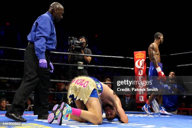 Prichard Colon holds his head after falling to the ring against Terrel Williams in their super welterweights bout at EagleBank Arena on the campus of...