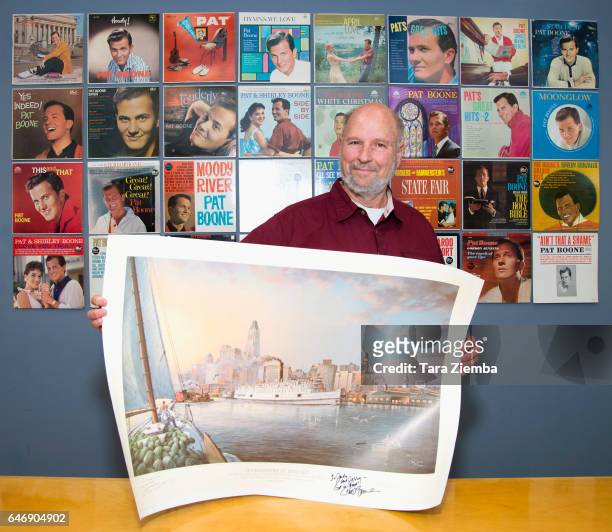 President of the Jewish American Society for Historic Preservation Jerry Klinger holds a 70th Anniversary Commemorative print honoring the Exodus...