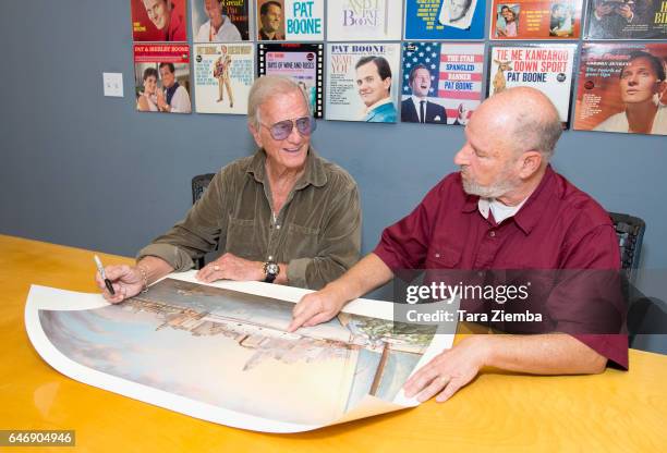 Singer Pat Boone and President of the Jewish American Society for Historic Preservation Jerry Klinger sign a 70th Anniversary Commemorative print...