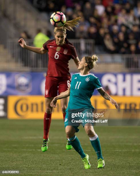 Morgan Brian of the United States of America leaps for the ball against Anja Mittag of Germany in the first half during the SheBelieves Cup at Talen...