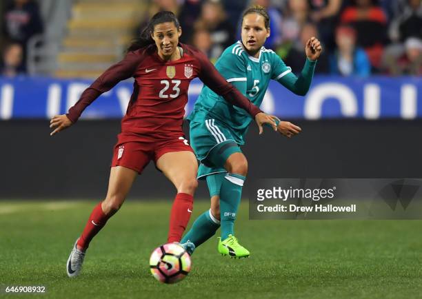 Christen Press of the United States and Babett Peter of Germany play the ball during the SheBelieves Cup at Talen Energy Stadium on March 1, 2017 in...