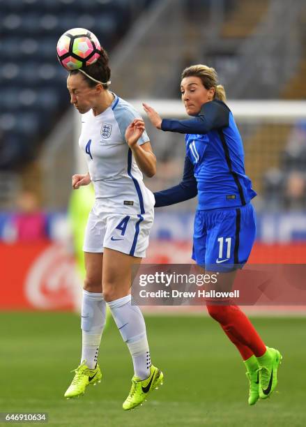 Lucy Bronze of England heads the ball in front of Claire Lavogez of France during the SheBelieves Cup at Talen Energy Stadium on March 1, 2017 in...