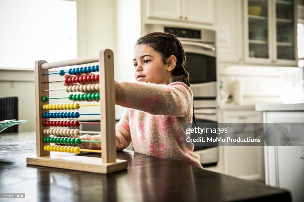 Girl (7 yrs) using abacus