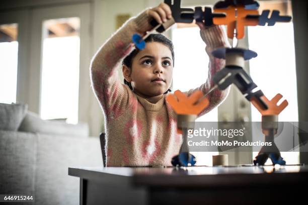 Girl building robot (7 yrs)