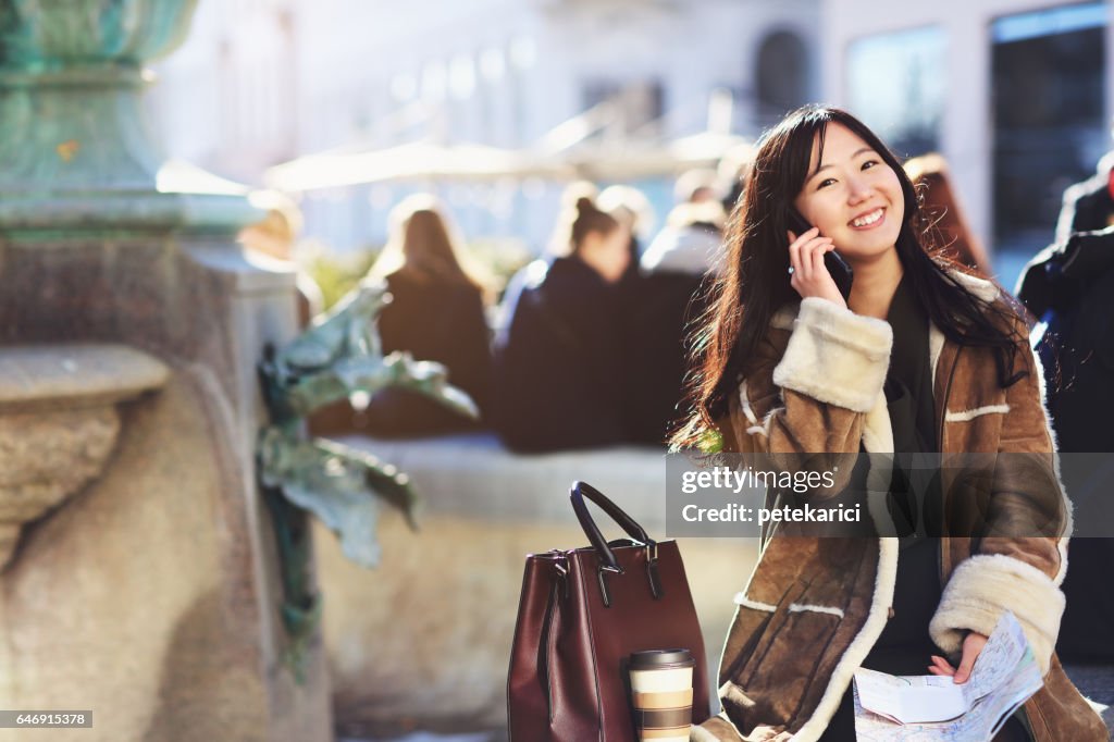 Happy japanese woman tourist in Nyhavn, Copenhagen