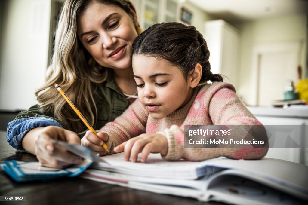 Mother and daughter (7 yrs) doing homework