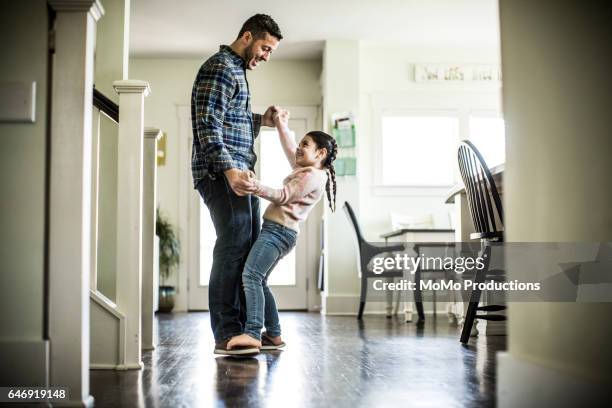 girl (7yrs) dancing on father's feet - father daughter dance stock-fotos und bilder