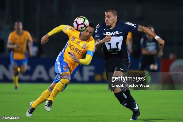 Juninho of Tigres struggles for the ball with Nicolas Castillo of Pumas during the quarterfinals second leg match between Pumas UNAM and Tigres UANL...