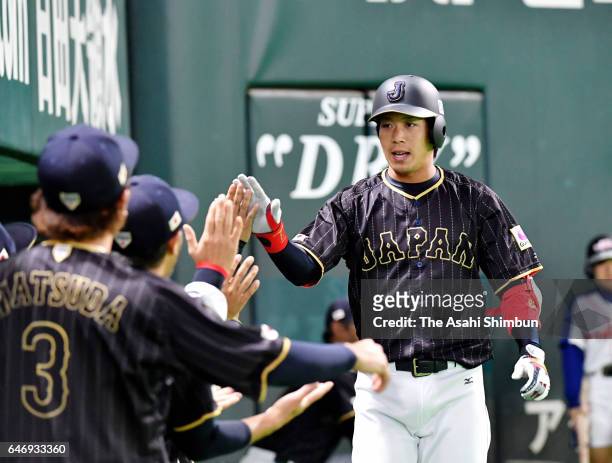 Infielder Tetsuto Yamada of Japan high fives with his team mates after hitting a solo homer in the top of first inning during the SAMURAI JAPAN...