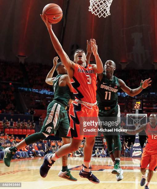 Te'Jon Lucas of the Illinois Fighting Illini shoots the ball between Alvin Ellis III and Lourawls Nairn Jr. #11 of the Michigan State Spartans at...