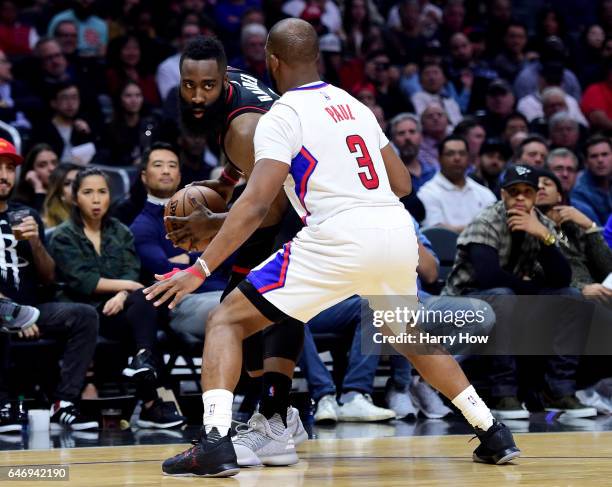 James Harden of the Houston Rockets is guarded by Chris Paul of the LA Clippers during the first half at Staples Center on March 1, 2017 in Los...
