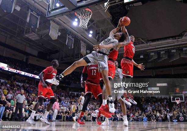 Donovan Mitchell of the Louisville Cardinals blocks a shot by John Collins of the Wake Forest Demon Deacons during the game at the LJVM Coliseum...