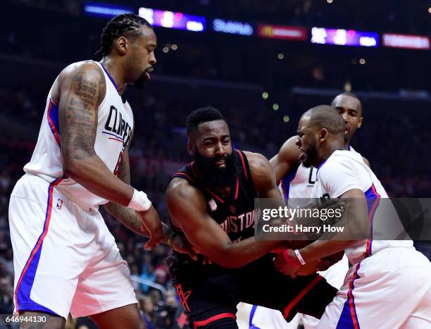 James Harden of the Houston Rockets loses the ball to Chris Paul of the LA Clippers as DeAndre Jordan looks on during the first half at Staples...