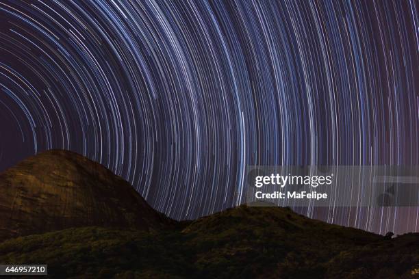 star trail over mountain in rio de janeiro - star trail stock pictures, royalty-free photos & images