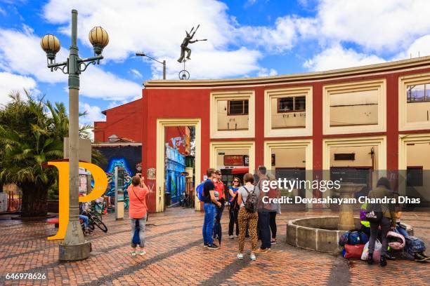 bogota, colombia - visitors on plaza chorro de quevedo in the la candelaria district - plaza del chorro de quevedo stock pictures, royalty-free photos & images
