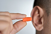 man putting on an earplug