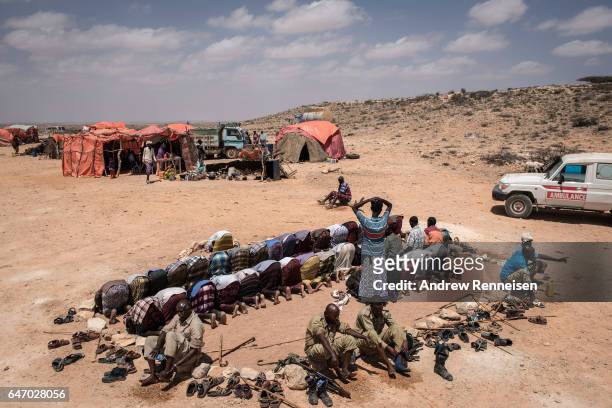 Men pray at an IDP camp on February 24, 2017 in Karin Sarmayo, Somalia. Brief rains brought an estimated 100,000 people to the region in search of...