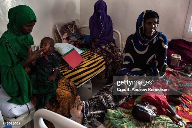 Women and children sit inside the malnutrition ward at Garowe General Hospital on February 27, 2017 in Garowe, Somalia. Somalia is currently on the...