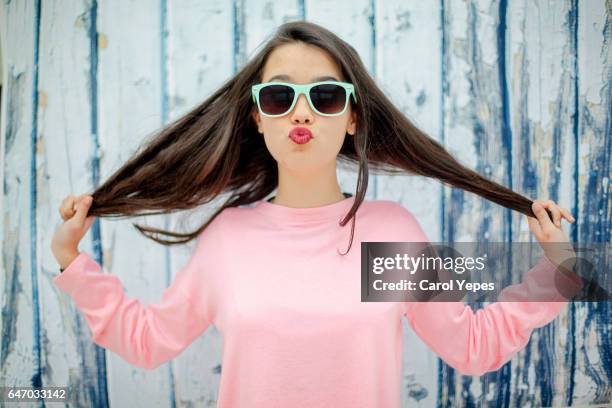 teenager girl playing with hair with fun expression - girl with beautiful hair stock pictures, royalty-free photos & images