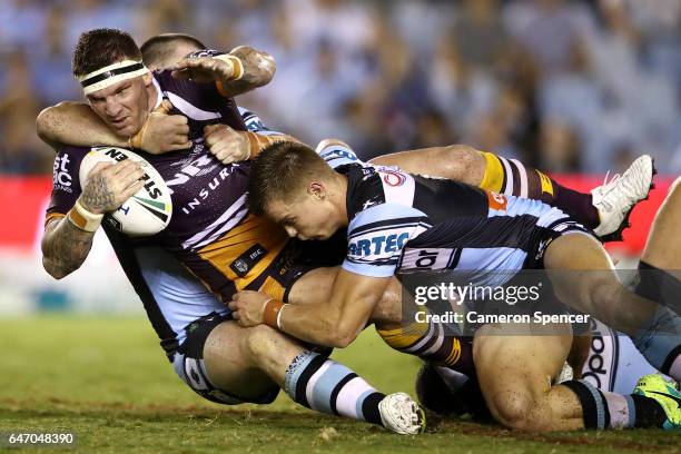 Josh McGuire of the Broncos is tackled during the round one NRL match between the Cronulla Sharks and the Brisbane Broncos at Southern Cross Group...