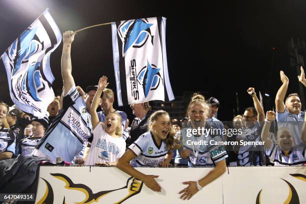 Sharks fans celebrate a try during the round one NRL match between the Cronulla Sharks and the Brisbane Broncos at Southern Cross Group Stadium on...