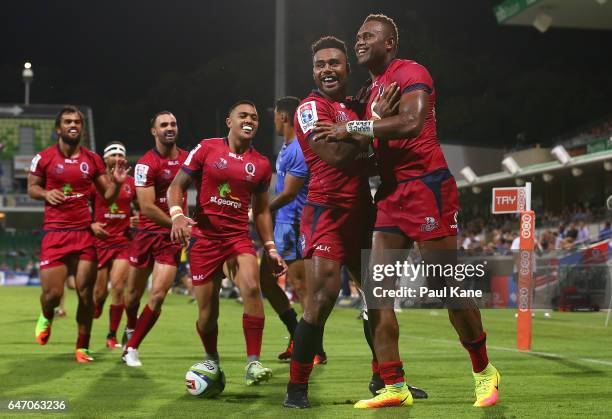 Eto Nabuli of the Reds is congratulated by Samu Kerevi after crossing for a try during the round two Super Rugby match between the Western Force and...