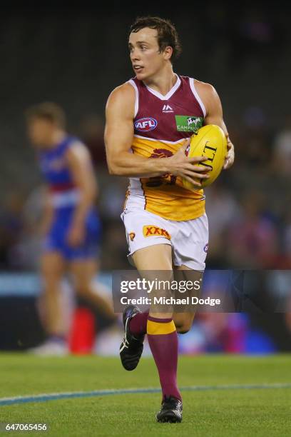 Lewis Taylor of the Lions looks upfield during the 2017 JLT Community Series AFL match between the Western Bulldogs and the Brisbane Lions at Etihad...