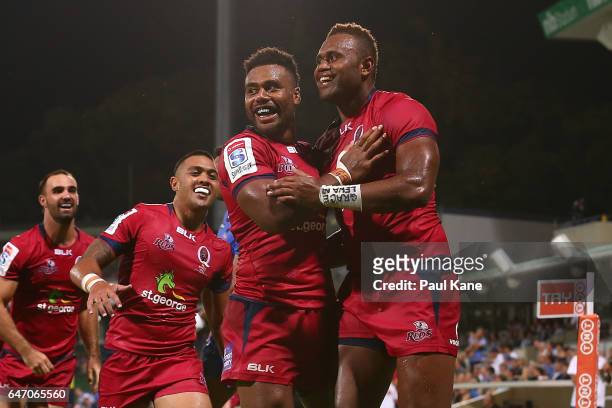 Eto Nabuli of the Reds is congratulated by Samu Kerevi after crossing for a try during the round two Super Rugby match between the Western Force and...