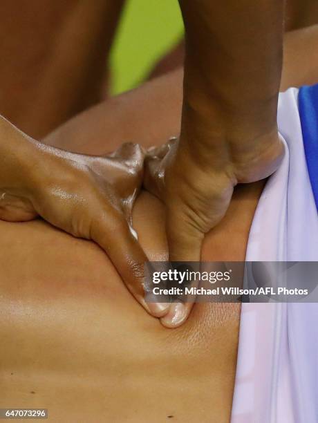 Clay Smith of the Bulldogs receives a massage during the AFL 2017 JLT Community Series match between the Western Bulldogs and the Brisbane Lions at...