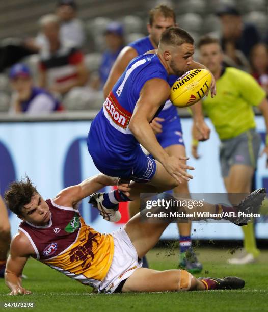 Matthew Suckling of the Bulldogs and Ben Keays of the Lions compete for the ball during the AFL 2017 JLT Community Series match between the Western...