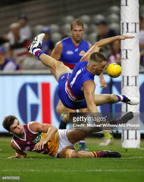 Matthew Suckling of the Bulldogs and Ben Keays of the Lions compete for the ball during the AFL 2017 JLT Community Series match between the Western...