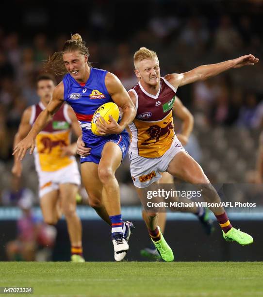 Roarke Smith of the Bulldogs and Nick Robertson of the Lions in action during the AFL 2017 JLT Community Series match between the Western Bulldogs...