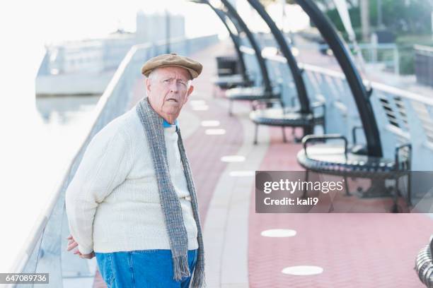 elderly man taking walk on pedestrian walkway - grumpy stock pictures, royalty-free photos & images